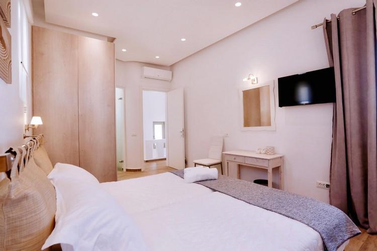 Villa_Yanni_16.jpg Fanari Mykonos 3rd Bedroom, curtains, flat screen tv, bed, pillows