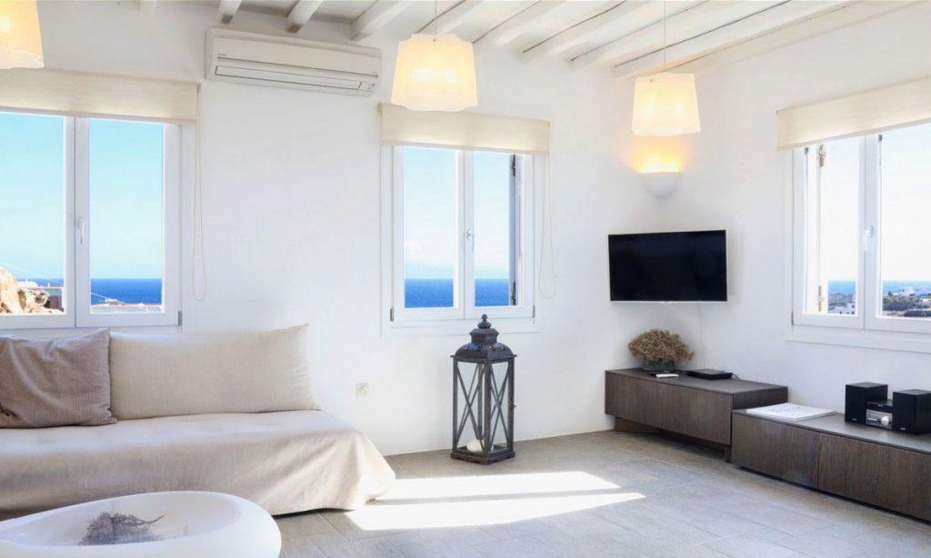 Villa-Agda_25.jpg Agios Ioannis Mykonos, living room, flat screen TV, AC, sofa, pillows, table, windows