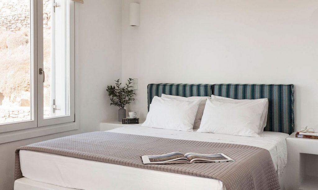 Villa-Agda_31.jpg Agios Ioannis Mykonos, 5th bedroom, king size bed, window, book, pillows, nightstand, flowers