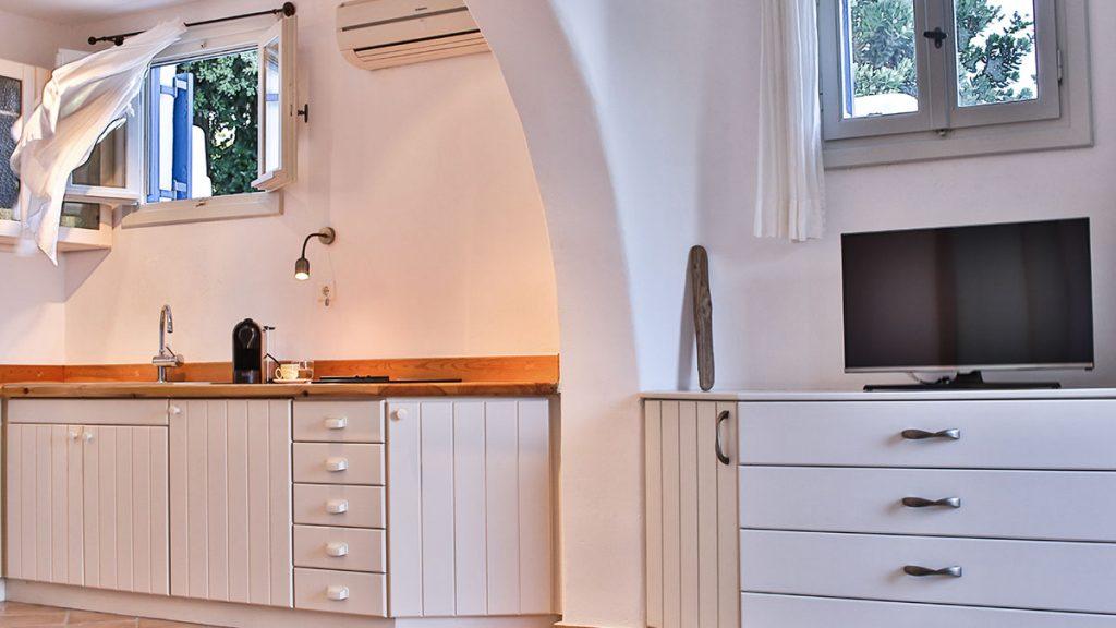 kitchen with wooden white cabins and air condition