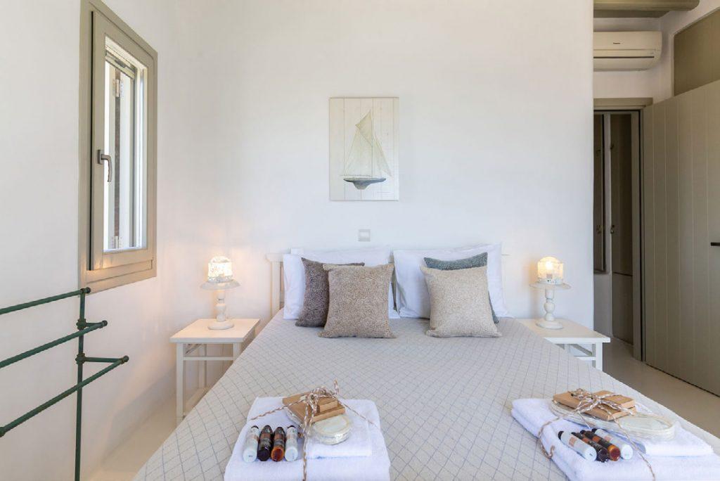 Villa-Camelia_26.jpg Agrari Mykonos, bedroom, nightstand, lamps, pillows, painting, AC, towels