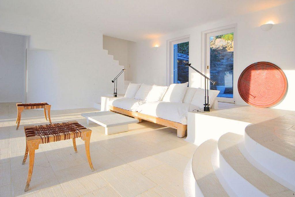 Villa-Parthenia_13.jpg Chora Mykonos, living room, table, sofa, pillows, stairs, windows