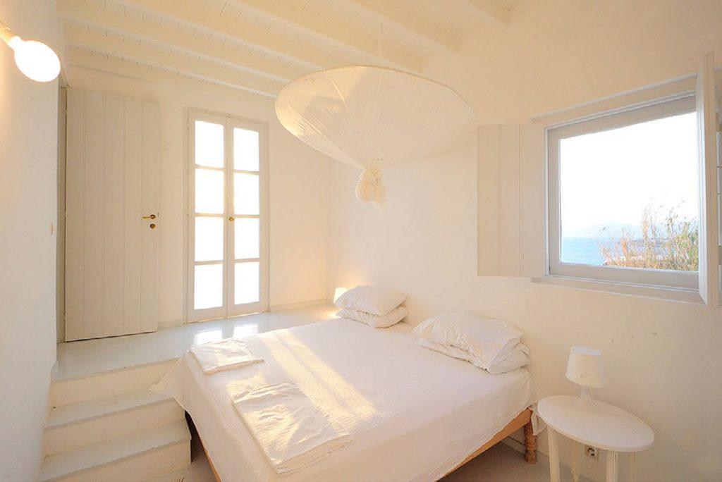 Villa-Parthenia_17.jpg Chora Mykonos, 2nd bedroom king size bed, nightstand, lamps, stairs, pillows