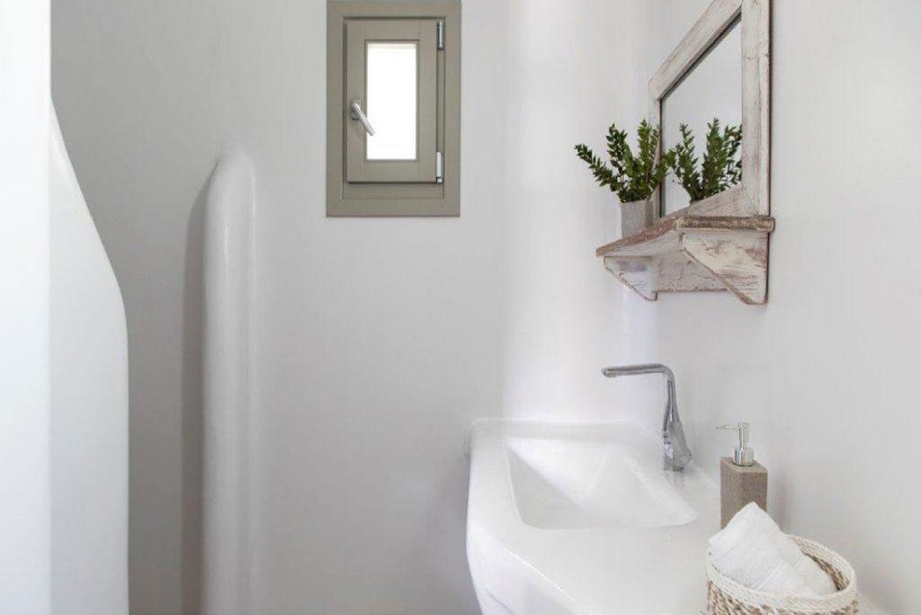 Villa-Sabina_51.jpg Kounoupas Mykonos, 4th bedroom, washstand, mirror, flowers, window, shower, soap, towels