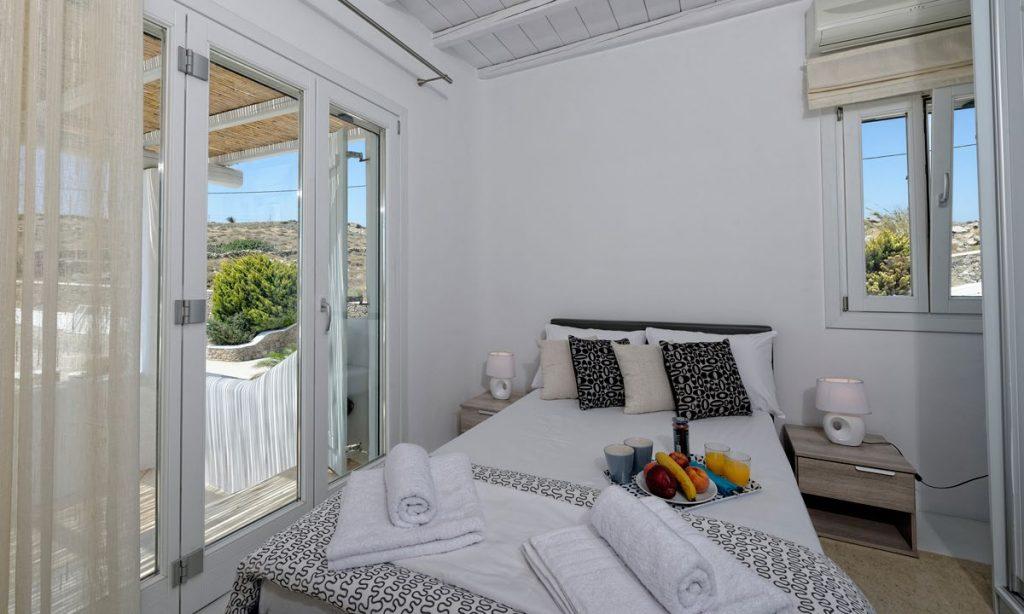 Villa-Valence-_24.jpg Kalafatis Mykonos, 1st bedroom, bed, pillows, nightstands, curtain, lamps, towels