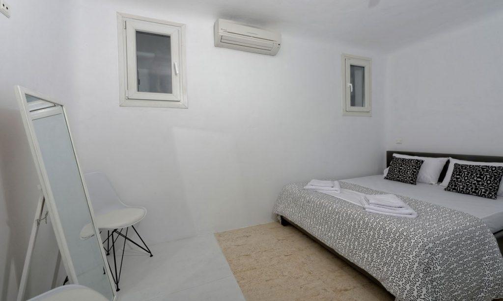 Villa-Valence-_26.jpg Kalafatis Mykonos, 3rd bedroom, mirror, king size bed, pillows, towels, windows, AC