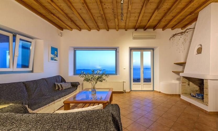 comfortably lit room with beautiful views of the coast and the sea
