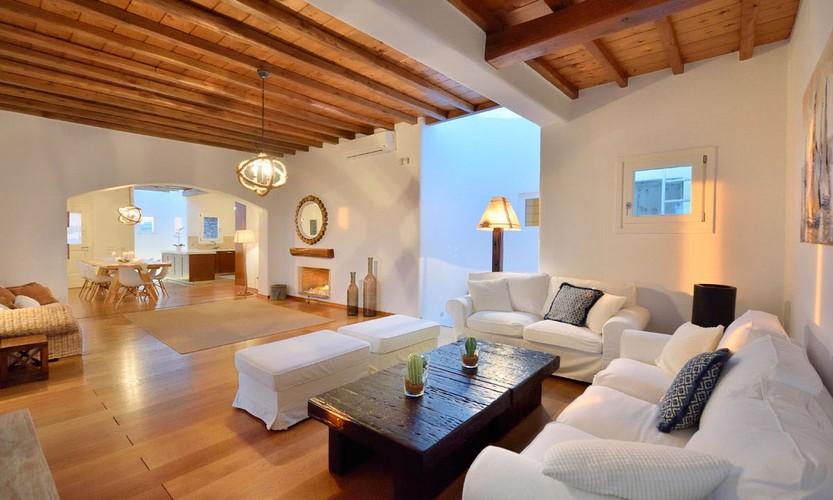 Villa_Patricia_22.jpg Super Paradise Mykonos Living area, bed, pillows, paint, carpet, fireplace