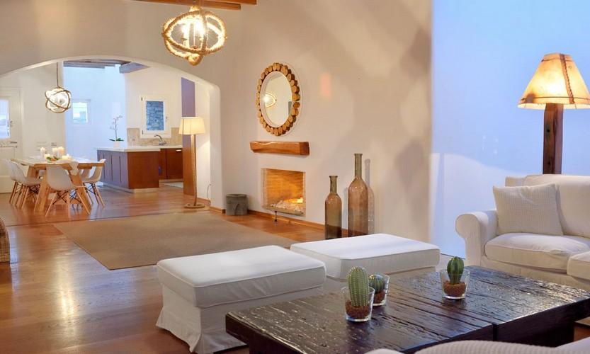 Villa_Patricia_23.jpg Super Paradise Mykonos Living area, table, chairs, lamp, mirror, fireplace