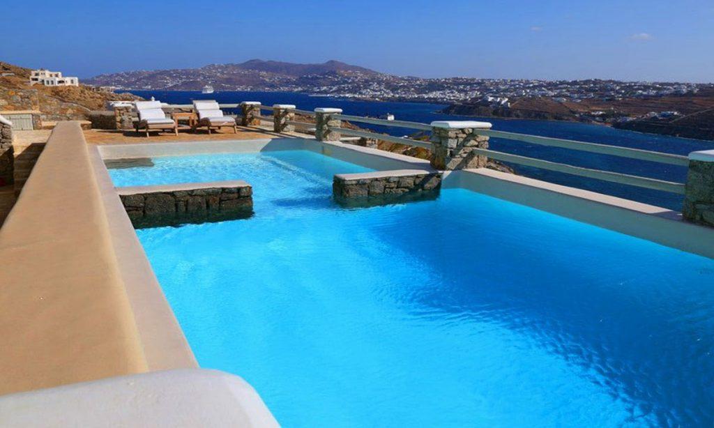 balcony with swimming pool and view of endless blue sea