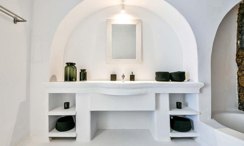 bathroom with lit mirror and shelf for staff