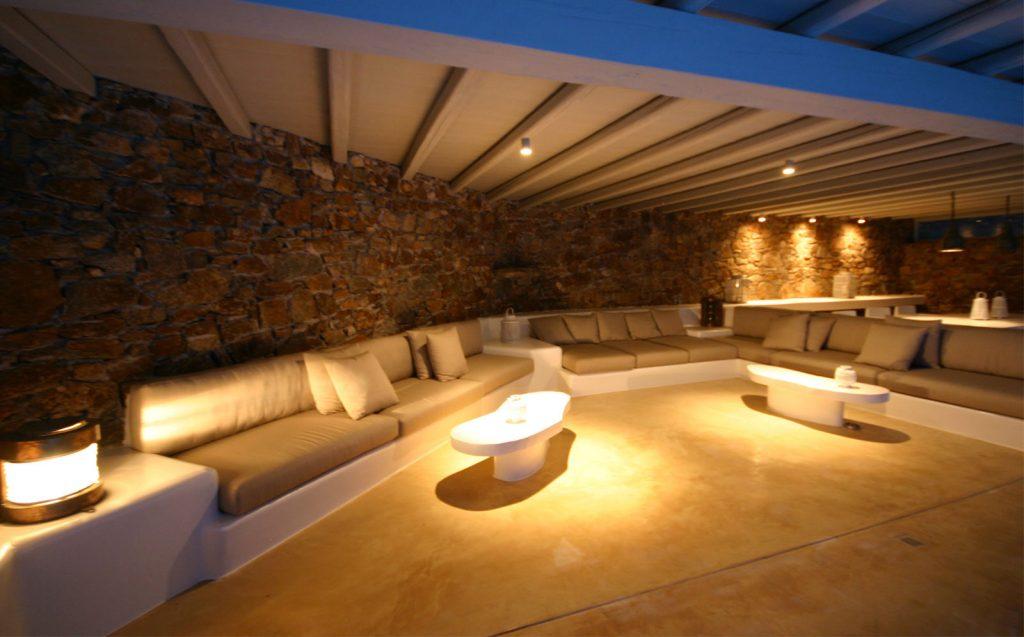 outdoor living area with stone walls and cozy couch