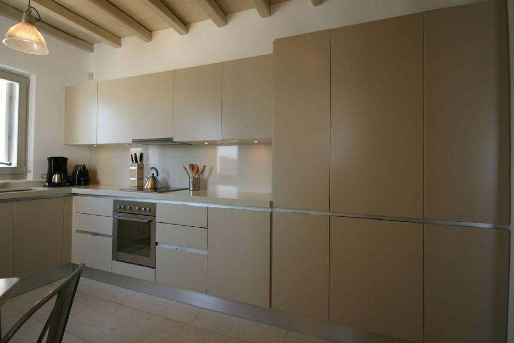 kitchen with modern beige cabins and still oven