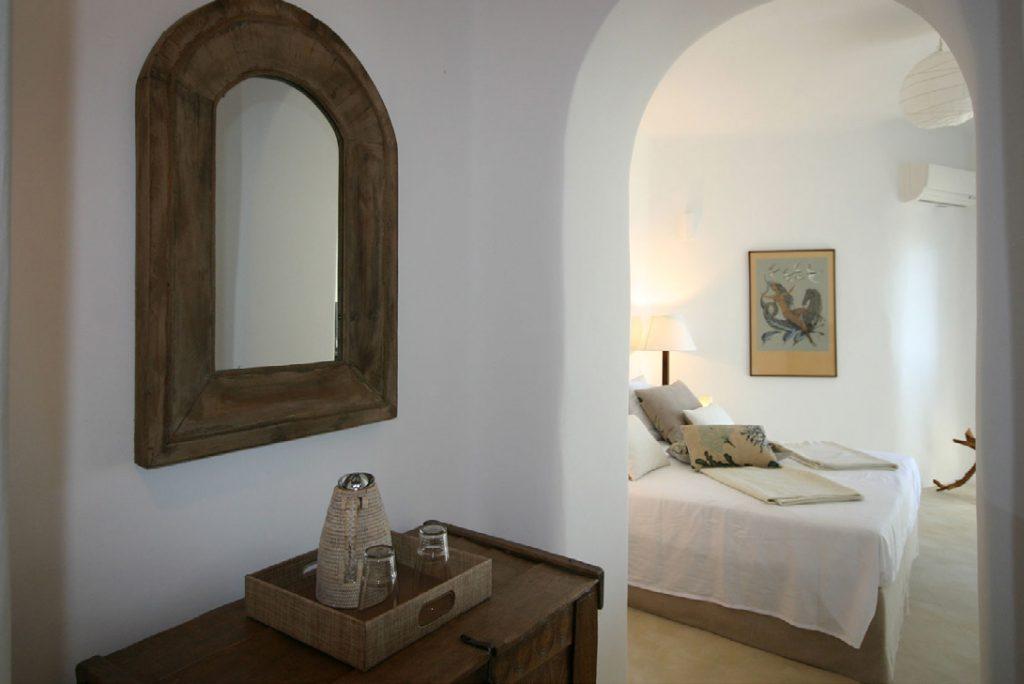 bedroom with hallway and wooden mirror frame
