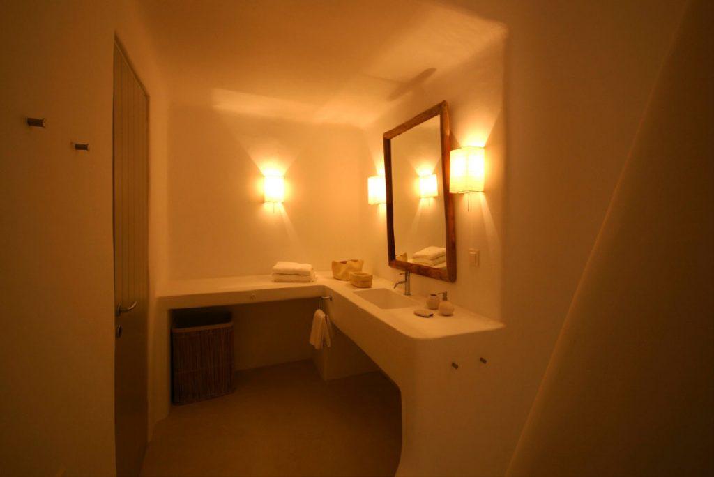 bathroom with wooden frame mirror and sink
