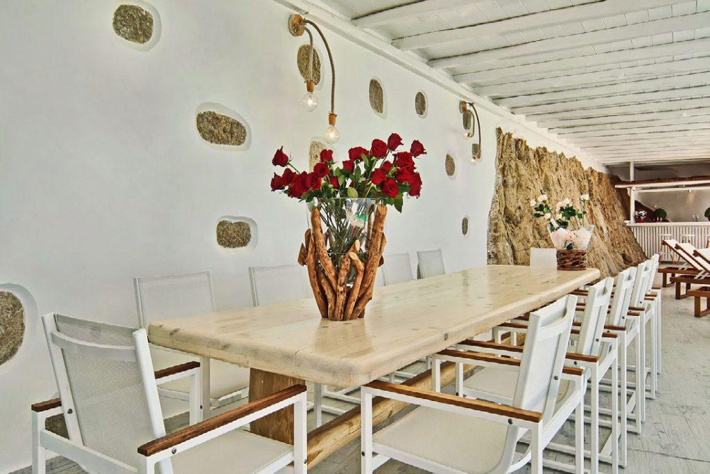 white stone wall dining room with roses and bar that promises great m