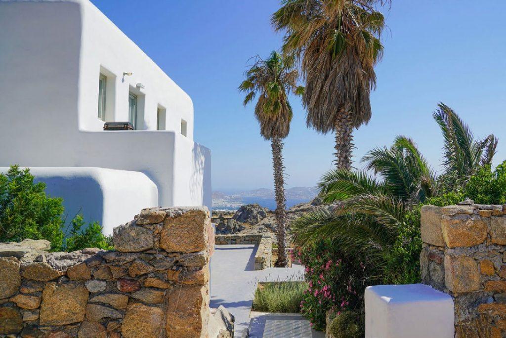 Villa Umabel, Agios Stefanos, Mykonos, Stone wall, Palms, White villa, Plants, Sea, Sky
