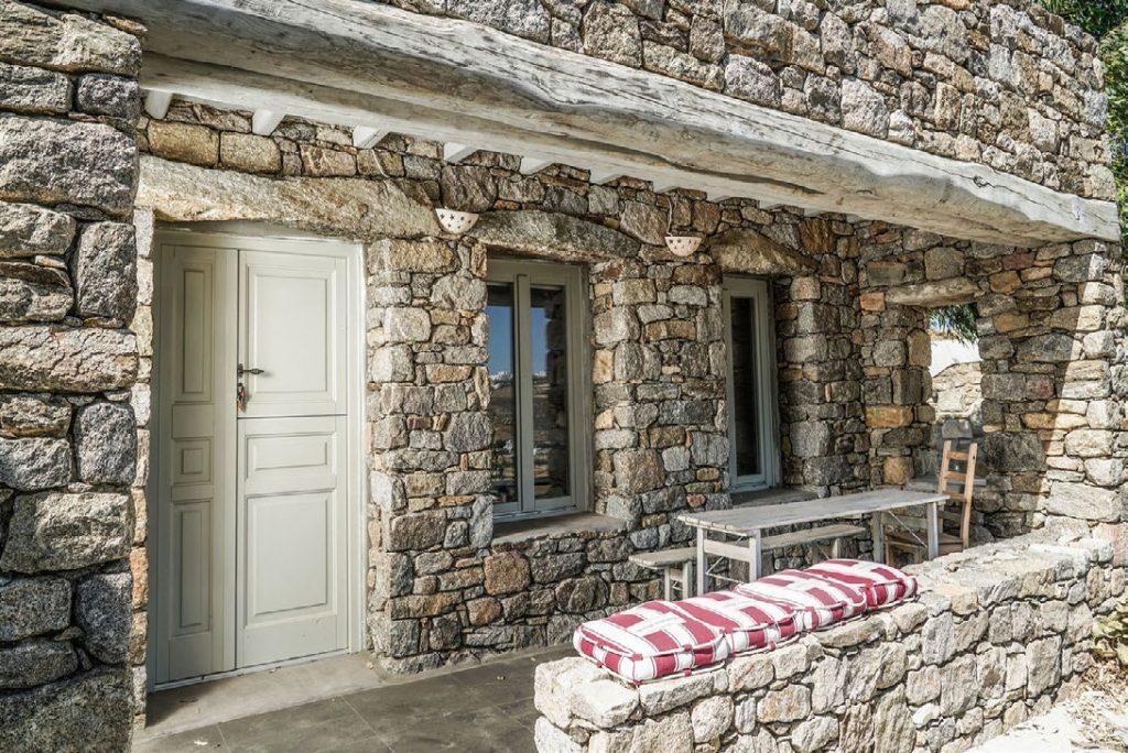 Villa Umabel, Agios Stefanos, Mykonos, Stone wall, Pillows, Windows, Chairs, Table, Door