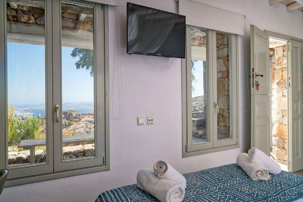 Villa Umabel, Agios Stefanos, Mykonos, Flatscreen TV, Windows, Door, Outside view, Sky, Towels, Stone wall