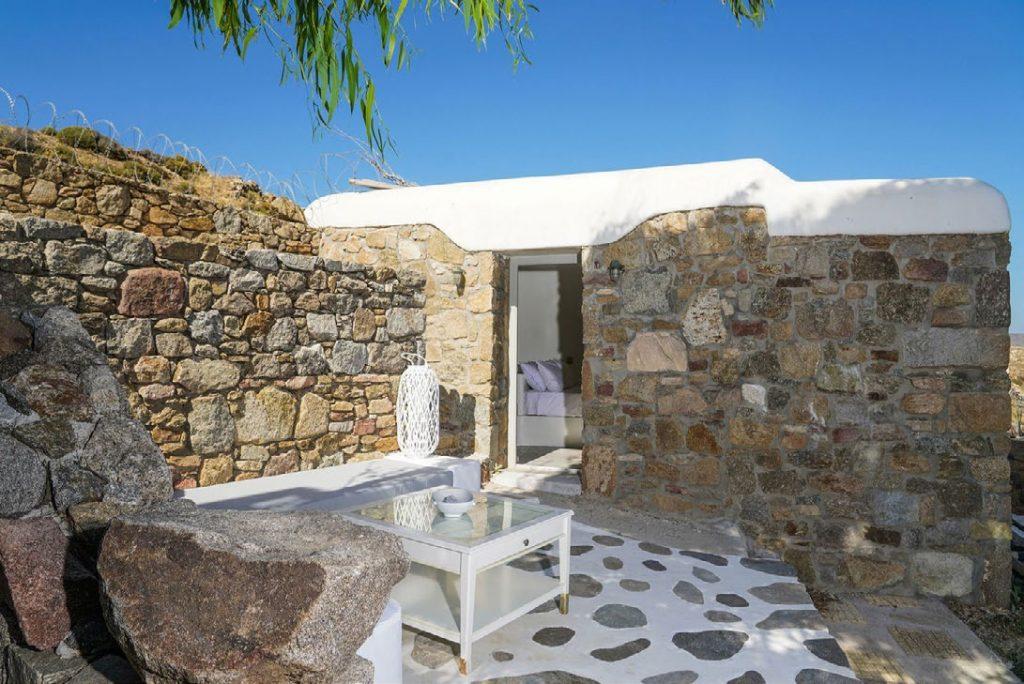 Villa Umabel, Agios Stefanos, Mykonos, Stone wall, Sky, Plant, Table, Pillows, Door