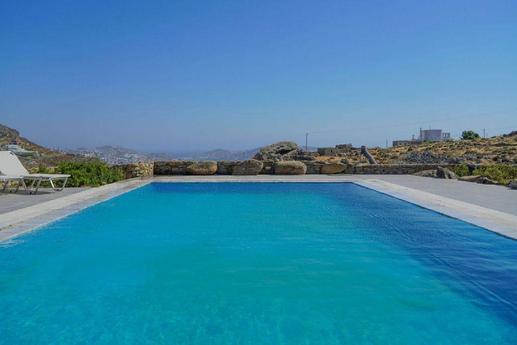 Villa Umabel, Agios Stefanos, Mykonos, Swimming pool, Pool, Stone wall, Sky, Sunbeds
