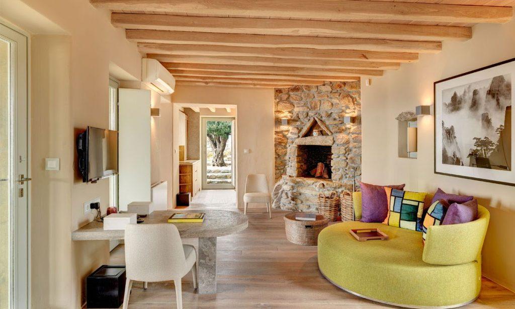 Villa Raisa Super Paradise Mykonos, living room, flat screen TV, AC, fireplace, sofa, pillows, table ,chairs, painting