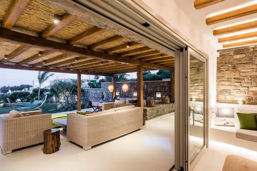 Villa_Levi_04.jpg Chora Mykonos Outdoor Living area, windows, pillows, lamp, climbers, wood, bed