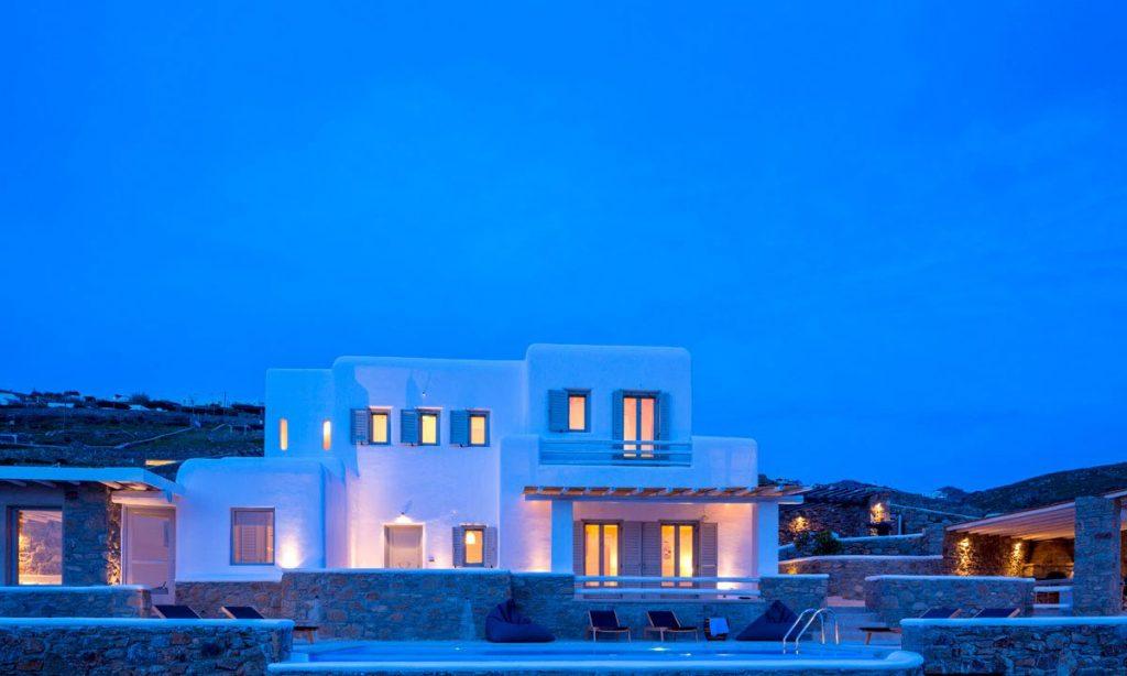 Villa Orion Retreat, Houlakia, Mykonos, villa exterior, sky, night, lights, pool, climbers, stone walls