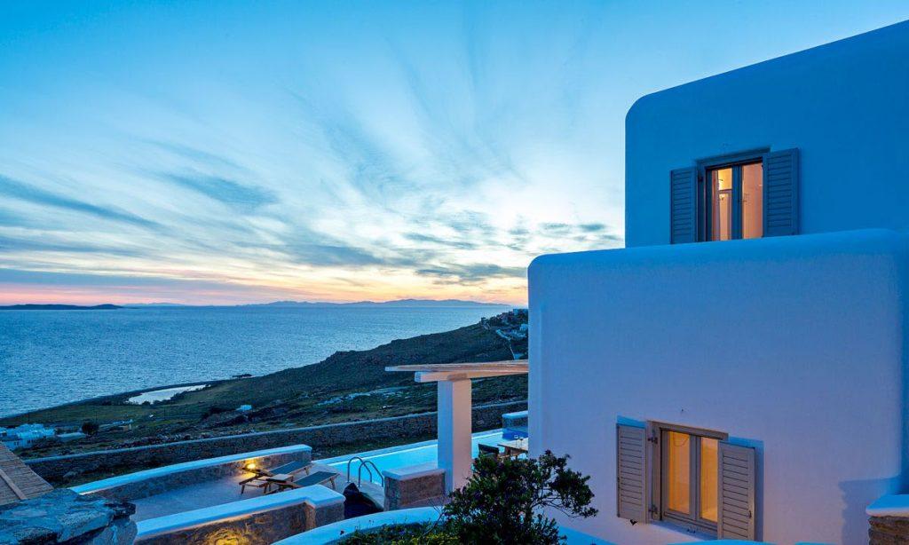 Villa Orion Retreat, Houlakia, Mykonos, villa exterior, pool, climbers, sea, sky, clouds