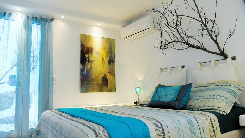 bedroom with tree branches and air condition