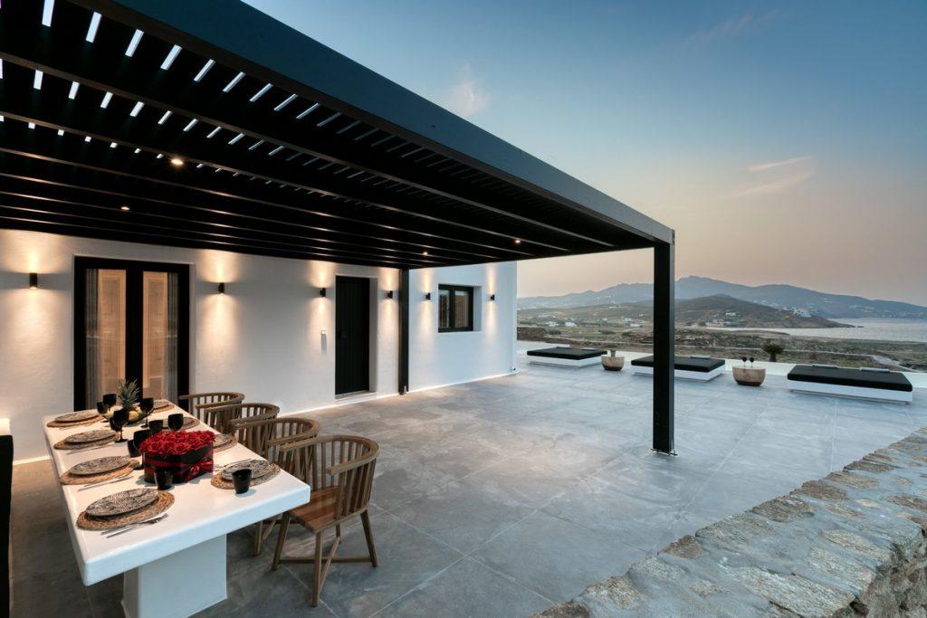 outdoor area with black canopy and huge dinner table