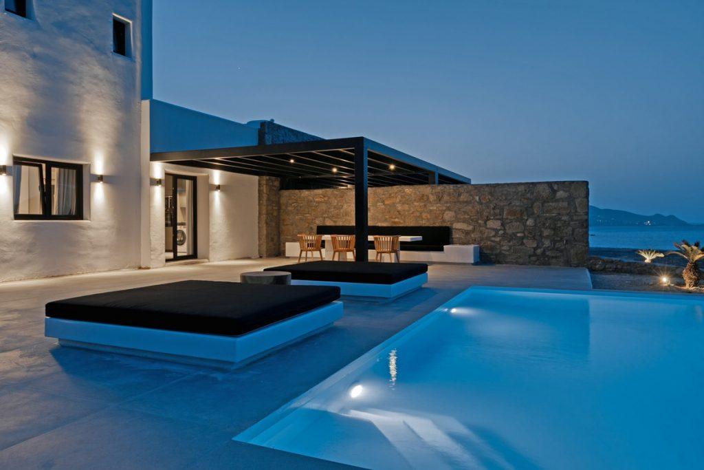 outdoor area with illuminated pool ideal for parties