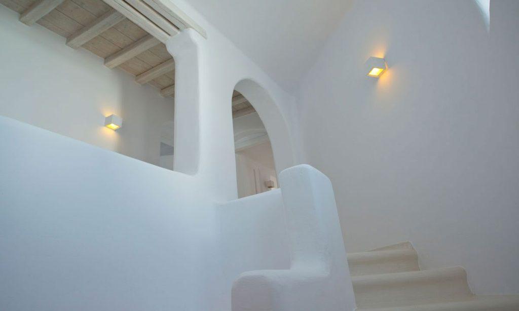 white stairs with wall lamp