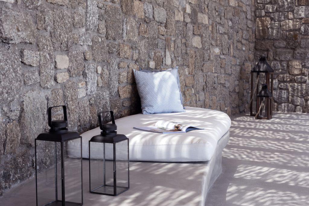white bed with blue big cushion to lay down and relax outside