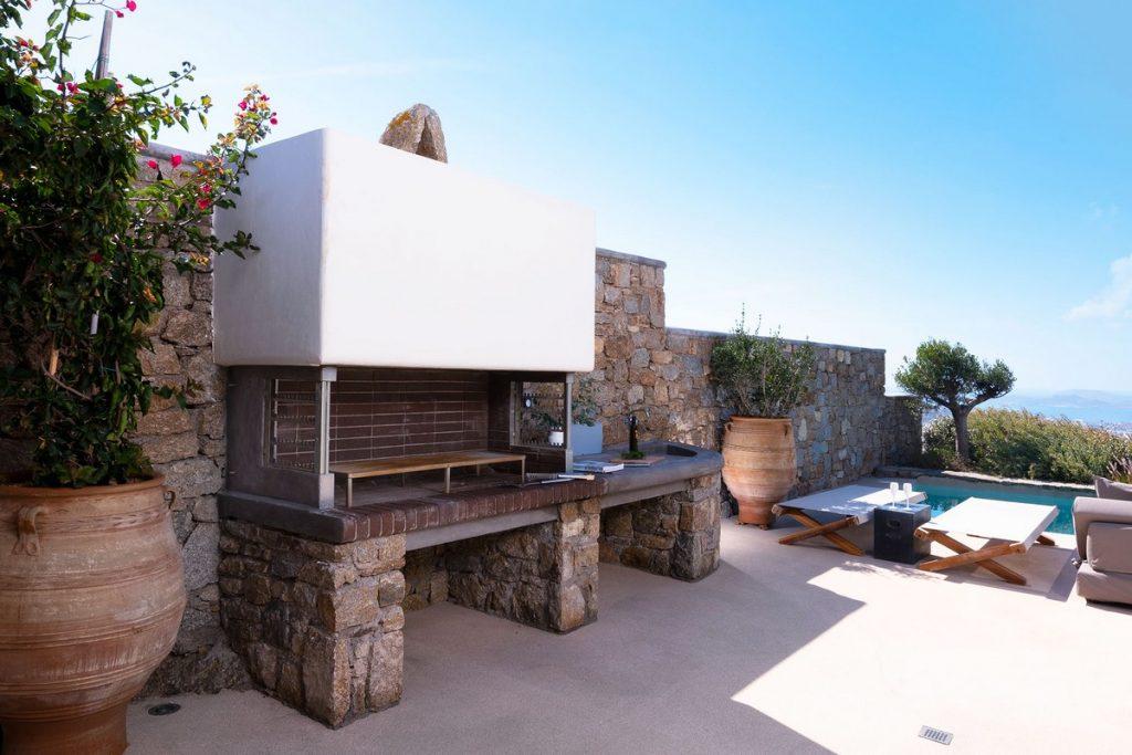 outdoor area with rock wall and BBQ