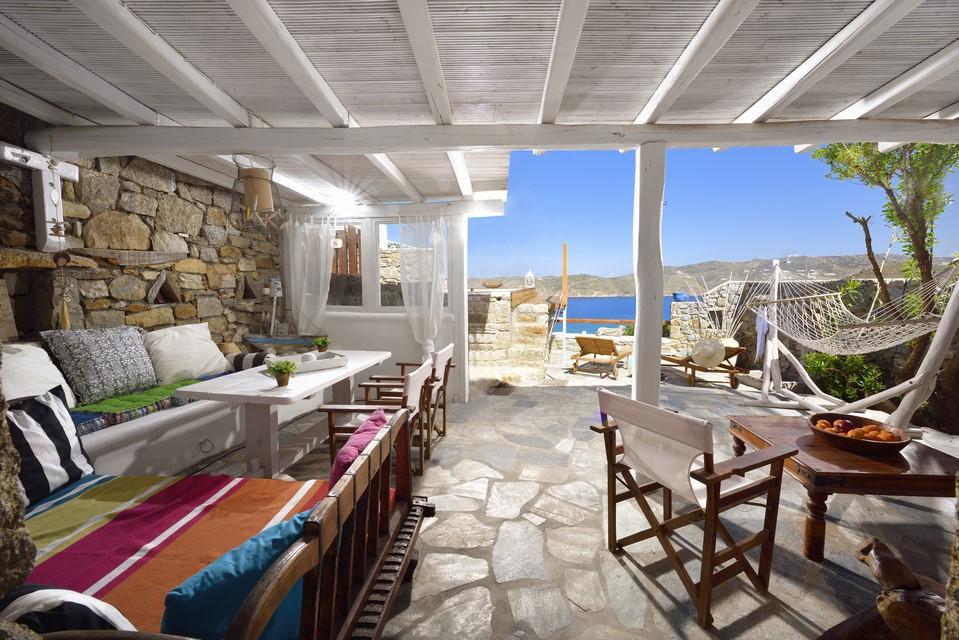 terrace with sea view stone walls and stairs leading to the pool and wicker swing great for enjoying a sunny day