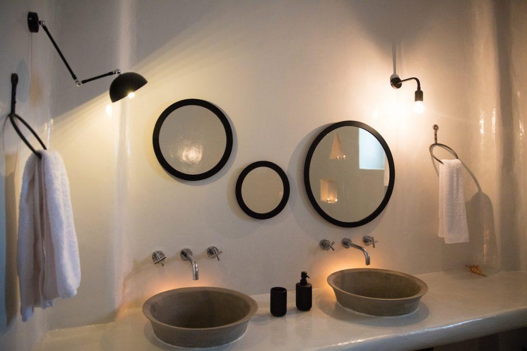 white wash walls with designed sink and lamp above