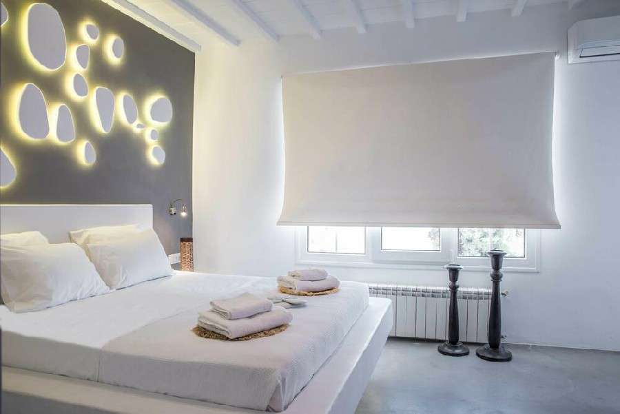 bedroom with walls lit by lamps for a romantic night