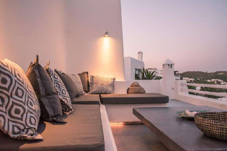 terrace with white walls and comfortable corner furniture ideal for enjoying a summer night
