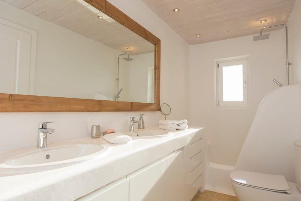 ideal bathroom for two with a large mirror and white sink