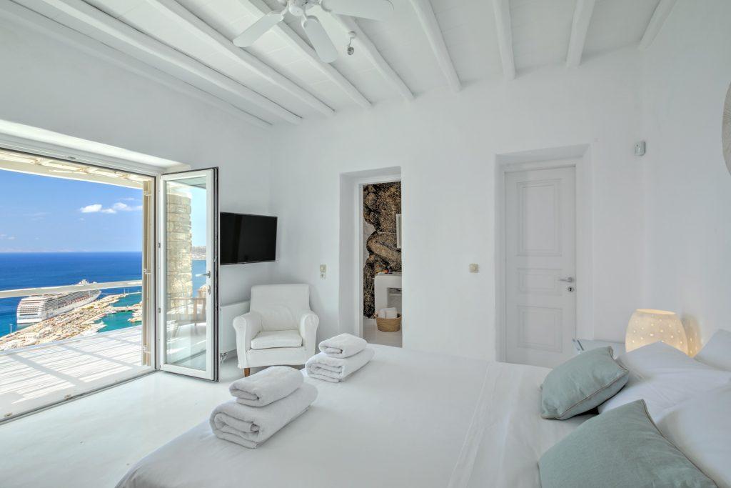spacious white wall bedroom with breathtaking horizon view