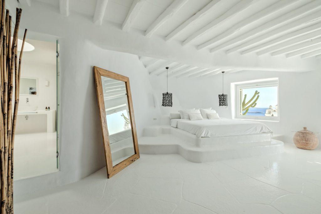 simple designed bedroom all in white with sea view