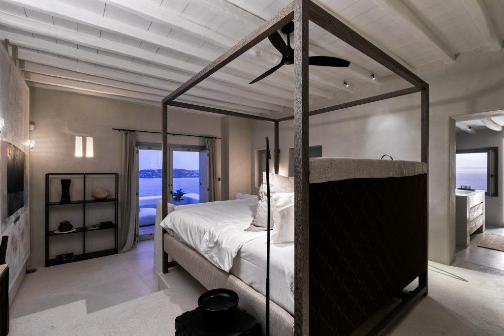 bedroom with grey walls that has a beautiful sea view