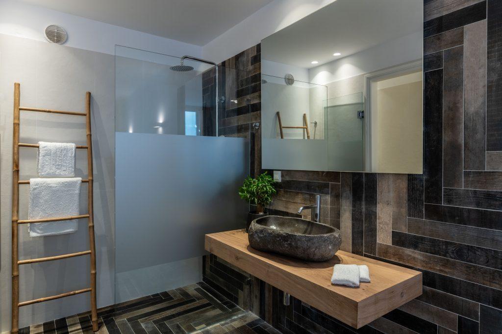 modern designed bathroom with tiled walls and ceramic sink