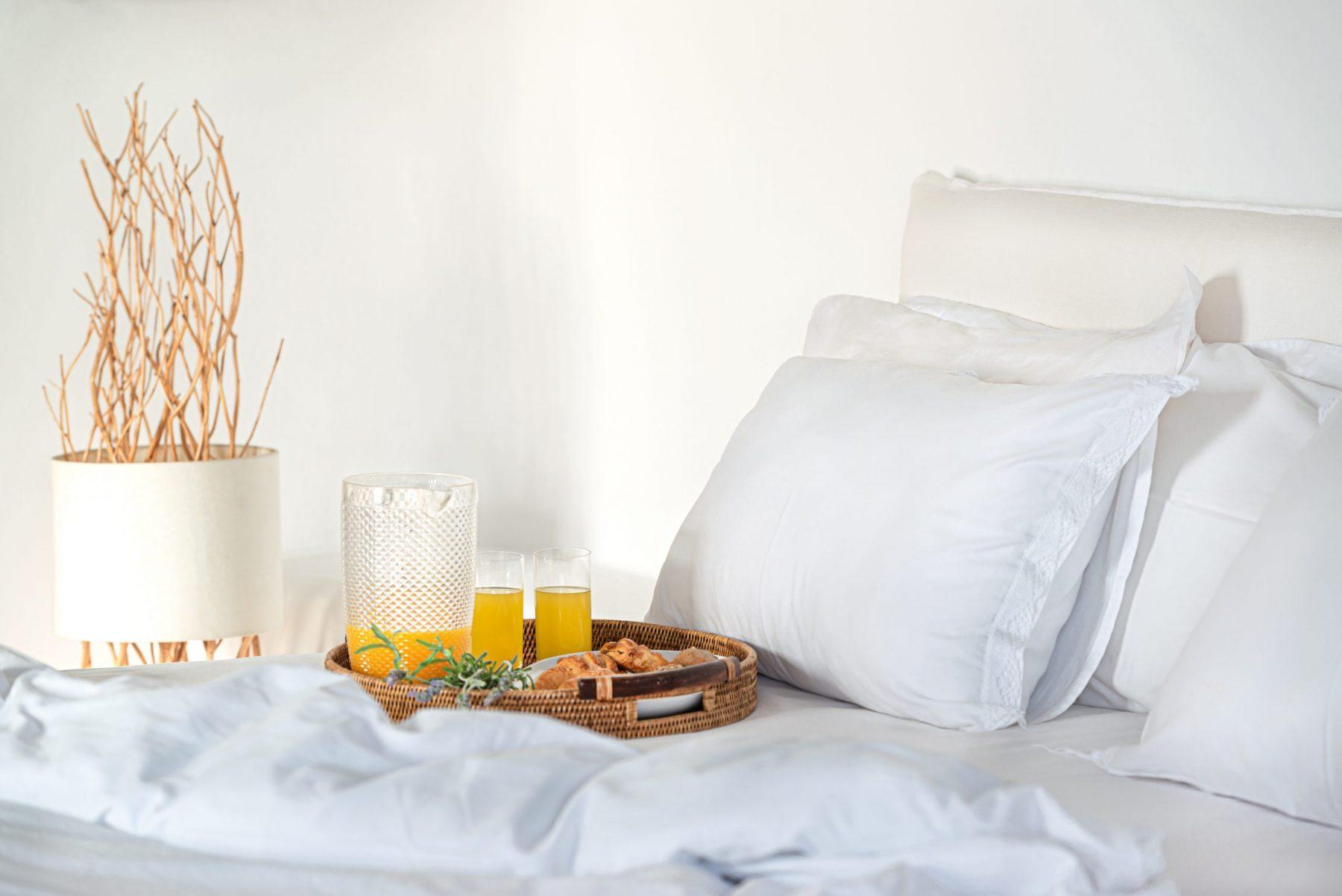 View of breakfast served on a bed in a luxury Mykonos villa rental