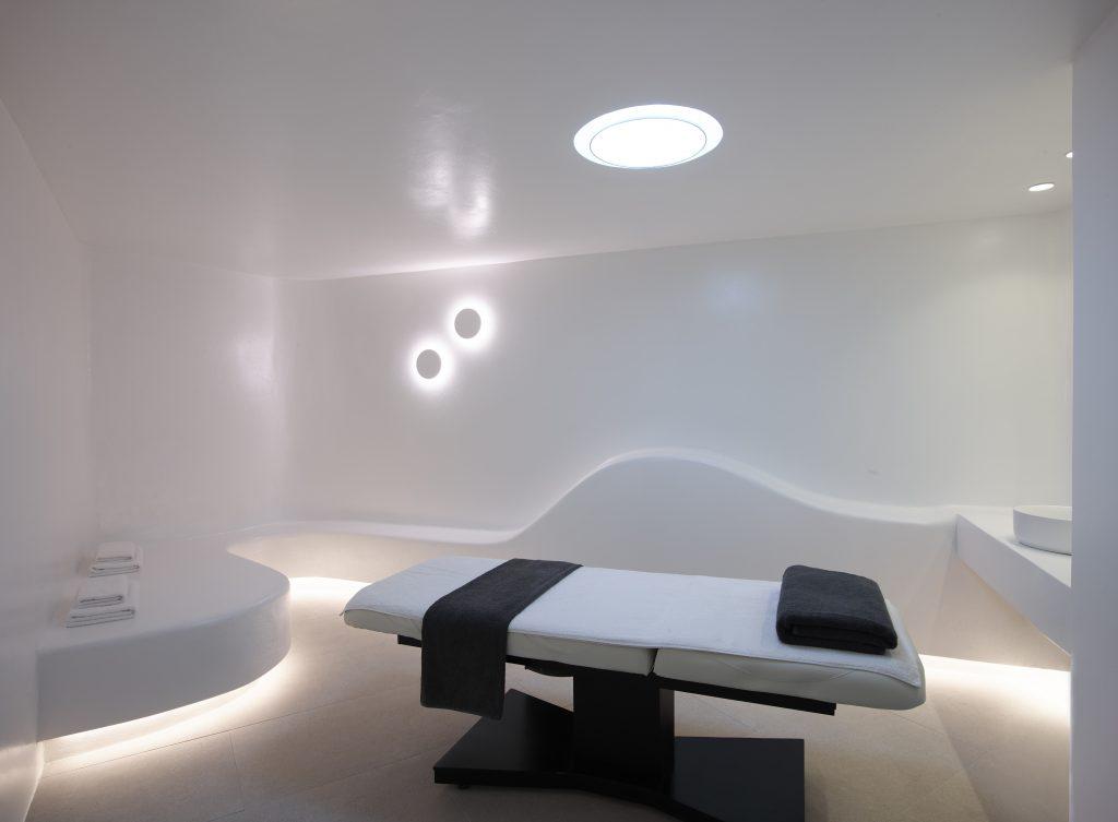 big illuminated room with massage table in the middle