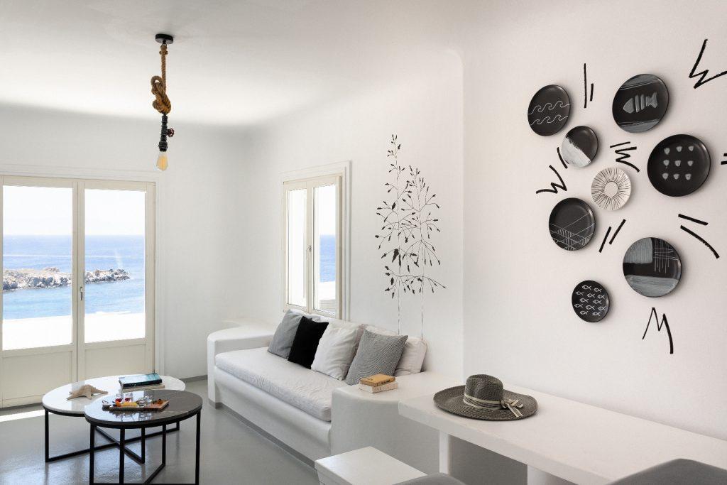 living area with white soft couch and decorated wall plates