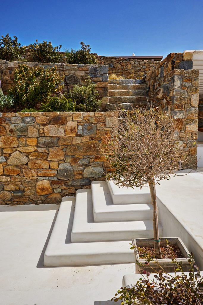 villa yard with greenery and stone walls