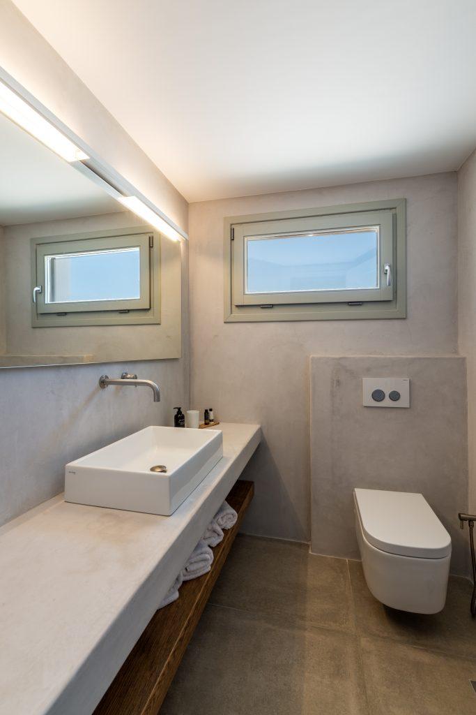 simple designed bathroom for cleaning and washing with big square mirror