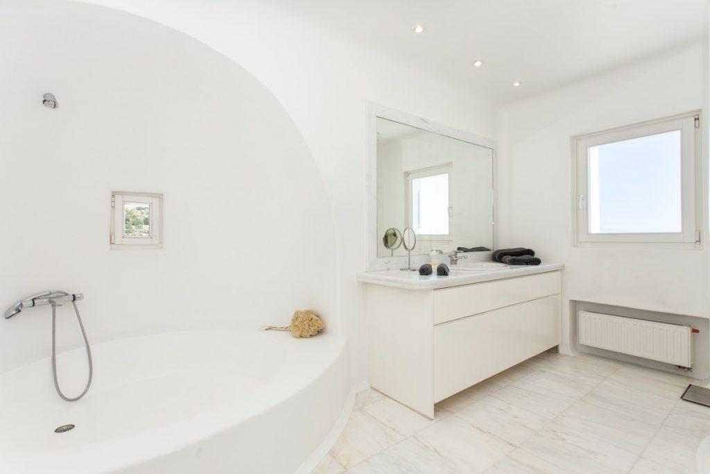 spacious bathroom with large white tub